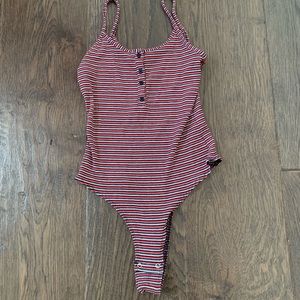 red, white and black ribbed body suit.